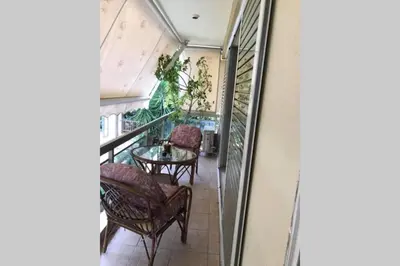 a balcony with chairs and a table in a building at Cosy & Functional pied-à-terre in Athens