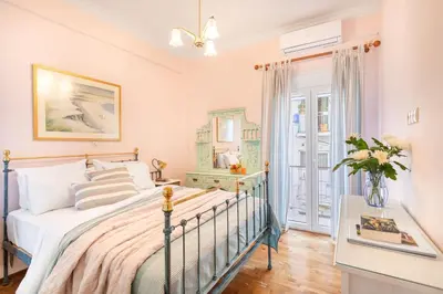 a bedroom with a bed and a table with a mirror at Bright, Calming Retreat With a Balcony Near Metro! in Athens