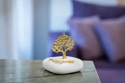 a miniature tree in a white rock on a table at Beautifully renovated flat in superb location in Athens