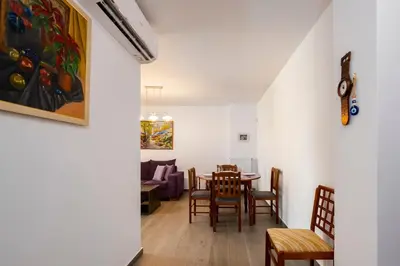 a dining room and living room with a table and chairs at Beautifully renovated flat in superb location in Athens