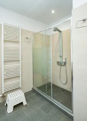 a shower in a bathroom with a glass shower stall at Beautifully renovated flat in superb location in Athens