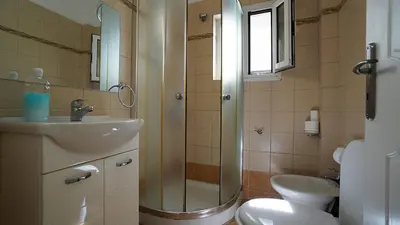 a bathroom with a shower and a sink and a toilet at athens city themis 11 in Athens