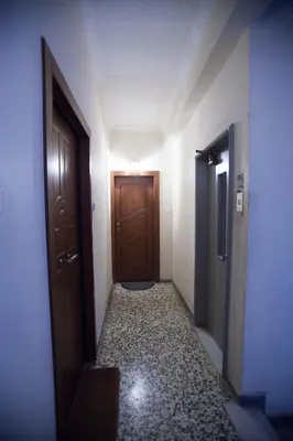 an empty hallway with a door and a floor with a hallway at athens city themis 11 in Athens