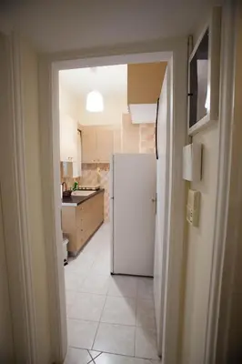 a kitchen with a white refrigerator in a room at athens city themis 11 in Athens