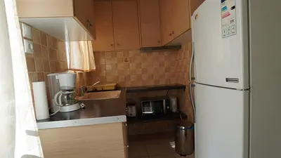 a small kitchen with a refrigerator and a microwave at athens city themis 11 in Athens