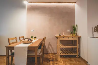 a dining room with a wooden table and chairs at 90m2 Luxury Apartment in the Heart of Athens - Living Stone Sunstone in Athens
