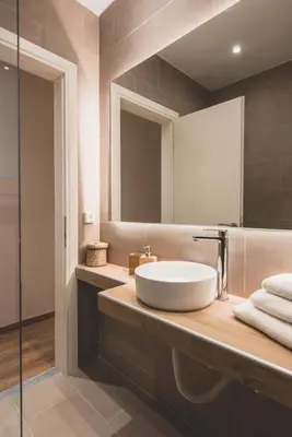 a bathroom with a sink and a mirror at 90m2 Luxury Apartment in the Heart of Athens - Living Stone Sunstone in Athens