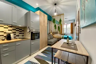 a kitchen with a table and a living room at Thissio, Downtown Athens by 'Philoxenia In Athens' in Athens
