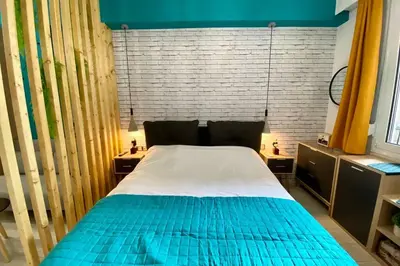 a bedroom with a bed with blue and white sheets at Thissio, Downtown Athens by 'Philoxenia In Athens' in Athens