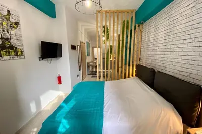 a bedroom with a bed and a brick wall at Thissio, Downtown Athens by 'Philoxenia In Athens' in Athens