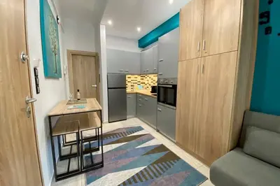 a kitchen with a table and a counter in a room at Thissio, Downtown Athens by 'Philoxenia In Athens' in Athens