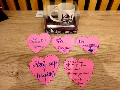four pink hearts with writing on them on a table with a cup at EcoStay-Serenity,business class apartment by the sea in Alimos Kalamaki in Athens