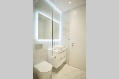 a white bathroom with a toilet and a sink at EcoStay-Serenity,business class apartment by the sea in Alimos Kalamaki in Athens