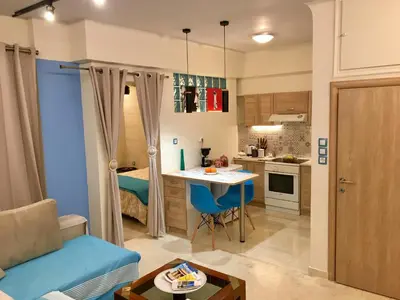 a small apartment with a kitchen and a living room at Piraeus Blue Grand Suite di Giorgio 10 mins from the port. in Piraeus