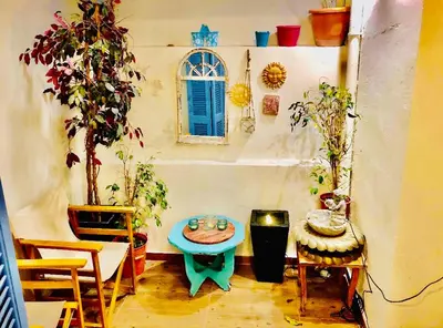 a room with a table and some plants and a window at Piraeus Blue Grand Suite di Giorgio 10 mins from the port. in Piraeus