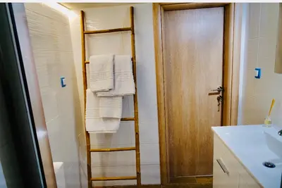 a bathroom with a towel rack and a sink at Piraeus Blue Grand Suite di Giorgio 10 mins from the port. in Piraeus