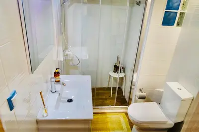 a bathroom with a white toilet and a sink at Piraeus Blue Grand Suite di Giorgio 10 mins from the port. in Piraeus