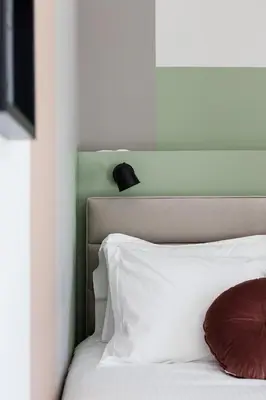 a bedroom with a white bed with a red pillow at Iconic 1BR Apartment in Koukaki by UPSTREET in Athens