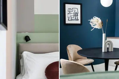 a room with a blue wall and a table and a bed at Iconic 1BR Apartment in Koukaki by UPSTREET in Athens