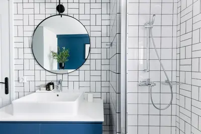 a white bathroom with a sink and a mirror at Iconic 1BR Apartment in Koukaki by UPSTREET in Athens