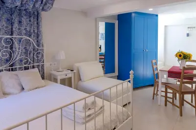 a bedroom with a bed and a table and a chair at Blue And White Apartment VIPGreece in Athens