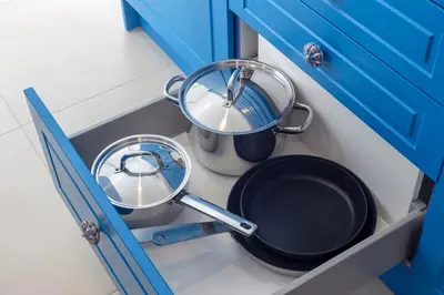 a kitchen with two pans and a pot in a drawer at Blue And White Apartment VIPGreece in Athens