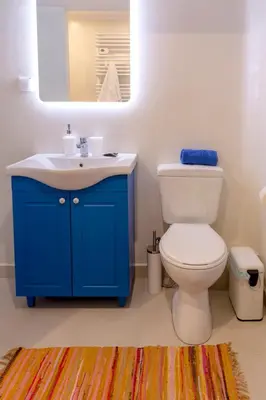 a bathroom with a blue sink and a toilet at Blue And White Apartment VIPGreece in Athens