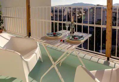 a table and chairs on a balcony with a view at Blue And White Apartment VIPGreece in Athens