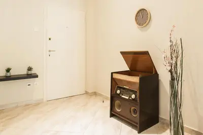 a room with a record player and a clock on the wall at La maison de Philopappou in Athens