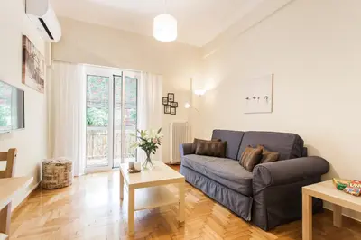 a living room with a couch and a table at La maison de Philopappou in Athens