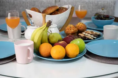 a table with a plate of fruit on a table at Polytimon, an Athenian neoclassical apartment in Athens