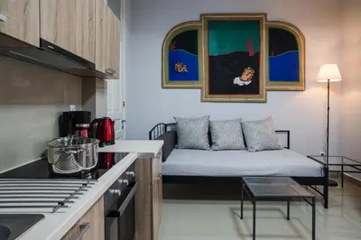 a small living room with a couch in a kitchen at Polytimon, an Athenian neoclassical apartment in Athens