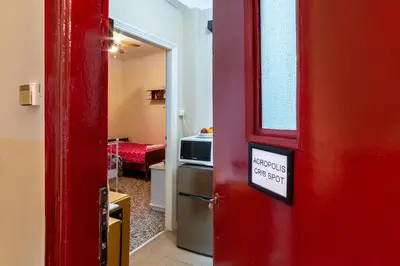 a red door with a sign on it next to a kitchen at Acropolis Crib Spot in Athens