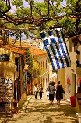 a group of people walking down a street at Acropolis Crib Spot in Athens