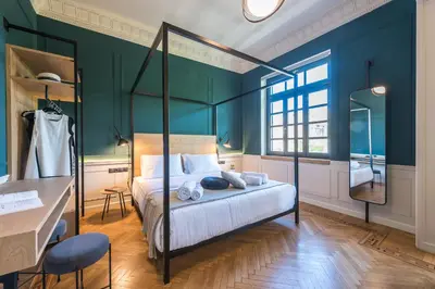 a bedroom with a bed with blue walls and a desk at Moon And Stars Athens in Athens