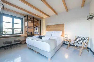 a bedroom with a bed and a desk and a chair at Moon And Stars Athens in Athens