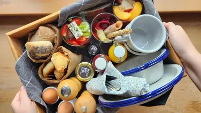 a box of food with eggs and vegetables on a table at Moon And Stars Athens in Athens