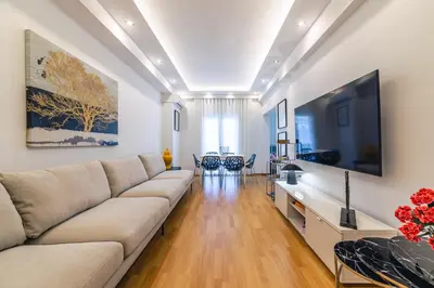 a living room with a couch and a flat screen tv at D9 center of Glyfada in Athens