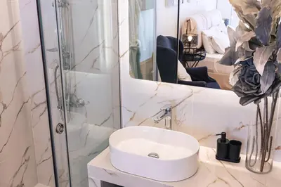 a bathroom with a white sink and a shower at D9 center of Glyfada in Athens
