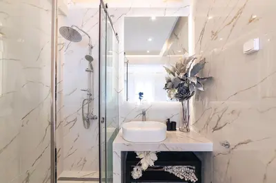 a white bathroom with a sink and a shower at D9 center of Glyfada in Athens