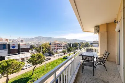 a balcony with a table and chairs and a view of a city at D9 center of Glyfada in Athens