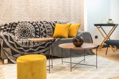 a living room with a couch and two tables at Brand New Ermou Veni Apartment in Athens