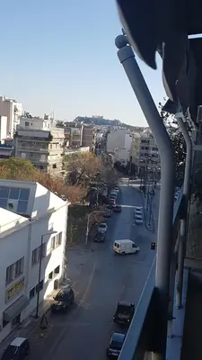 a view of a city street with cars parked on the road at Yianna's Apartment in Athens