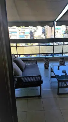 a couch sitting on top of a balcony at Yianna's Apartment in Athens
