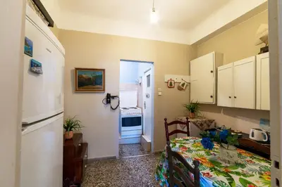 a kitchen and a dining room with a table at Acropolis Quiet House in Athens