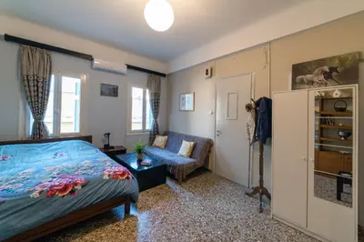 a bedroom with a bed and a couch at Acropolis Quiet House in Athens