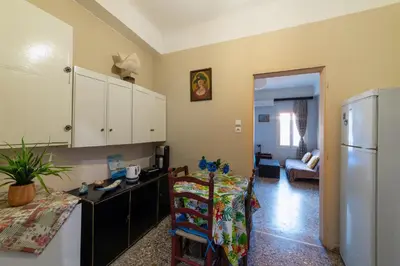 a kitchen with a counter and a refrigerator in it at Acropolis Quiet House in Athens