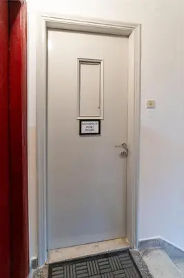 a white door with a sign on it at Acropolis Quiet House in Athens