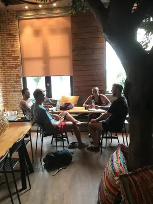 a group of people sitting at a table in a room at Iconic Athens Hostel in Athens