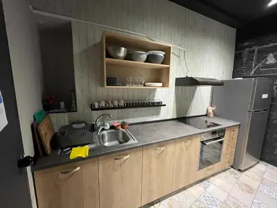a kitchen with a sink and a refrigerator at Iconic Athens Hostel in Athens